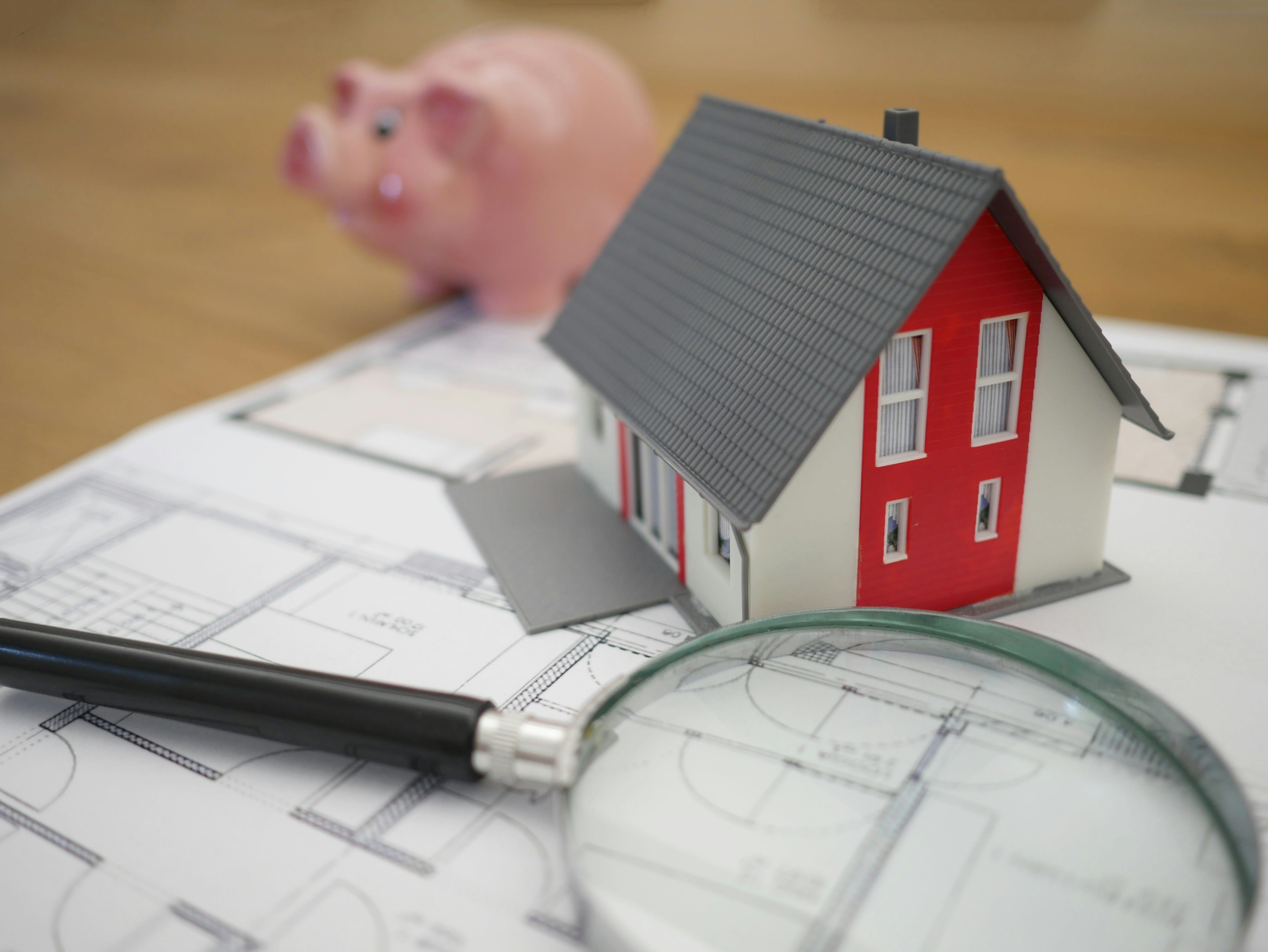 A financial calculator, legal paperwork, and house keys resting on a desk, illustrating South African property transfer costs and bond registration taxes.