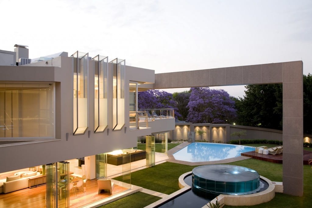 Modern mixed-use architectural property development with glass towers, green courtyards, and pedestrian walkways in South Africa