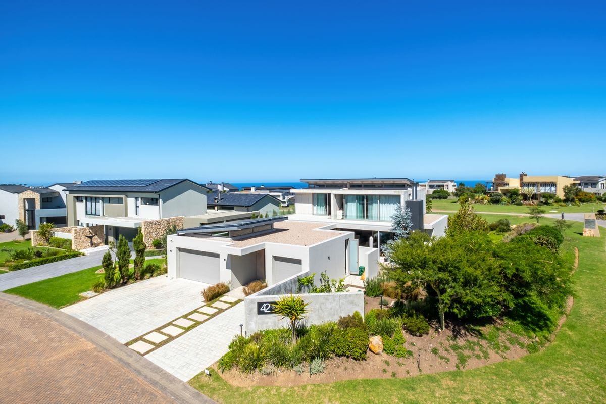 Modern eco-friendly secure estate home with solar panels and lush garden in South Africa